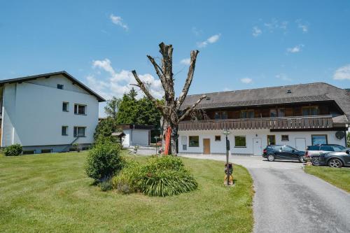 a dog is standing in front of a house at Villa Fernblick in Velden am Wörthersee