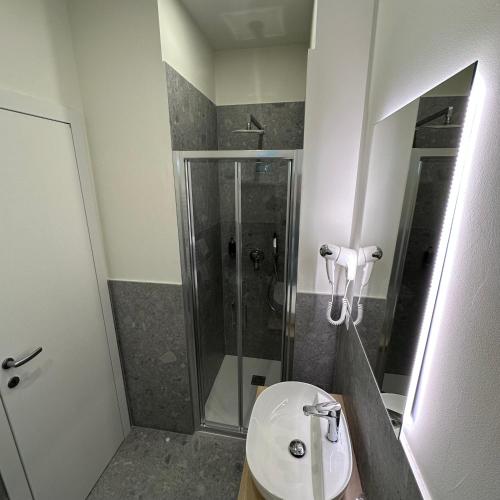 a bathroom with a shower and a white sink at Hotel St Gregory Park in Rimini