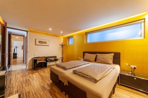 a bedroom with a large bed and a large window at Villa Alvarium in Schenna