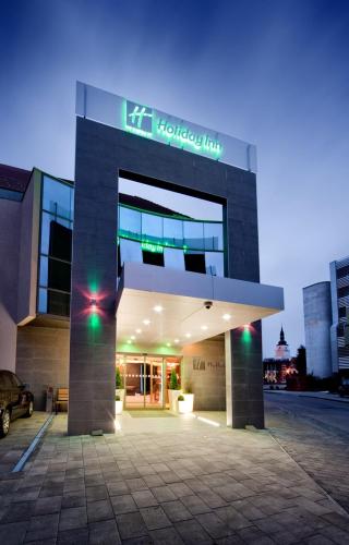 a building with a hudsonlaw sign on top of it at Holiday Inn Trnava by IHG in Trnava