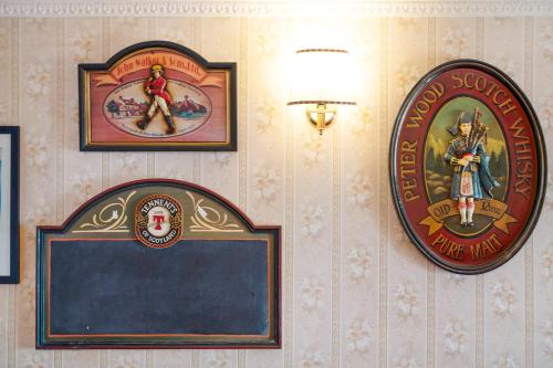 a wall with posters and a sign on it at Casa Scotland in Ventimiglia