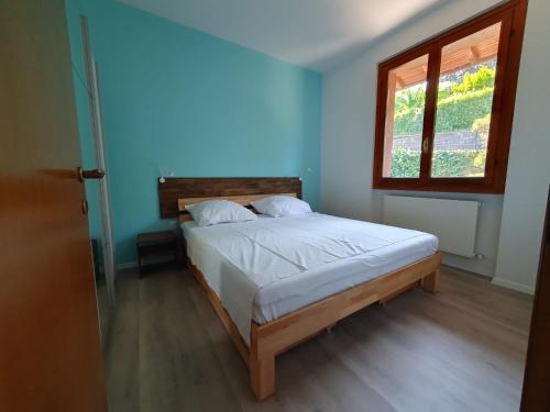 a bedroom with a bed in a room with a window at L'appartamento dell'arte in Cerro Lago Maggiore