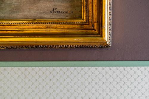 a painting with a gold frame on a wall at Residenza Villa Vecelli Cavriani in Mozzecane