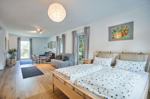 a bedroom with a bed and a living room at Ferienwohnung zum Steingarten in Krün