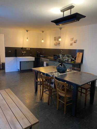 a kitchen with a table and chairs in a room at Artist's Home - Villa & Private Courtyard - 200m2 in Paris