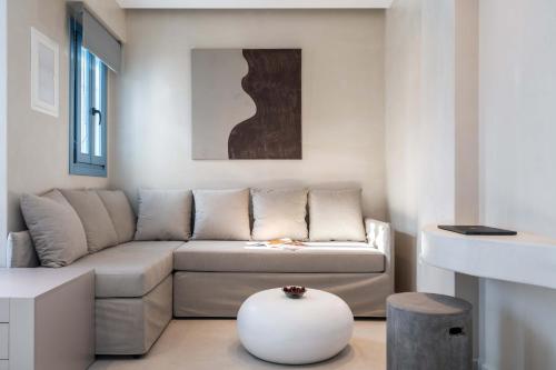 a living room with a couch and a table at Aura Suites Paros in Naousa