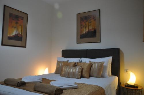 a bedroom with a large bed with towels on it at Manos House Hersonisos in Hersonissos