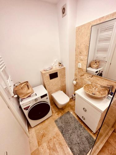 a small bathroom with a toilet and a sink at Avangarde Apartment in Bucharest