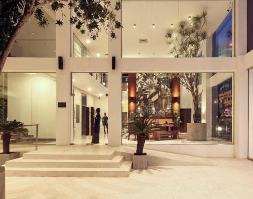 a lobby of a building with people standing in it at Morven Hotel Colombo in Colombo