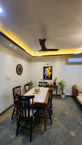 a living room with a table and chairs and a couch at Aaranya - A Boutique Stay in Bhopal