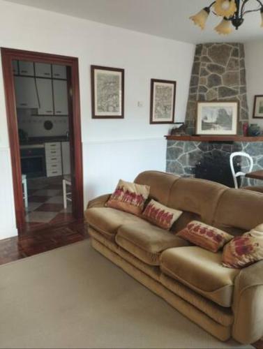 a living room with a couch and a fireplace at Casa La Bolera in Carreña de Cabrales 