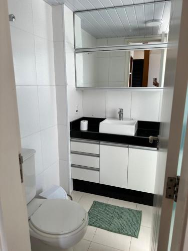 a bathroom with a white toilet and a sink at Apartamento Top Morumbi in São Paulo