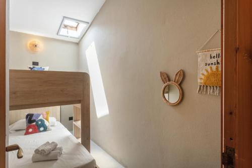 a small bedroom with a bed and a mirror at Baia Dorata beach apartments in Porto Istana
