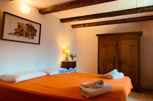 a bedroom with two beds with towels on them at One Step from Heaven by Holiday World in Baiardo