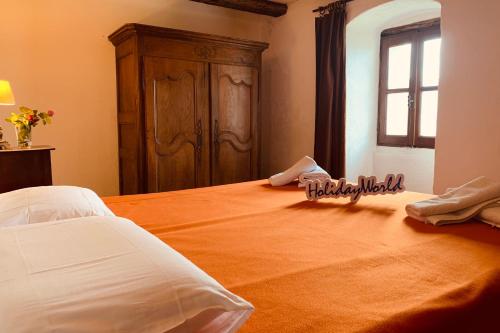 a bedroom with a large bed with a wooden cabinet at One Step from Heaven by Holiday World in Baiardo