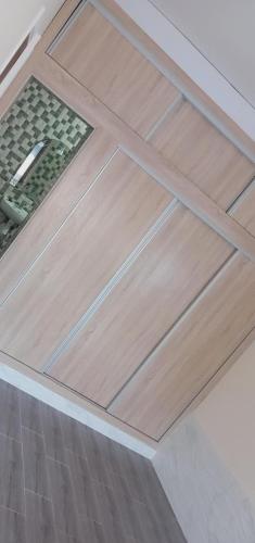 a wooden door on the floor of a kitchen at Appartement avec grande terrasse NEYLA Del Mar Inn Tanger in Tangier
