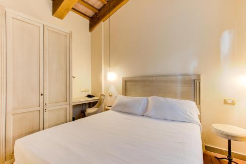 Postel nebo postele na pokoji v ubytování Oste del Castello Wellness & Bike Hotel