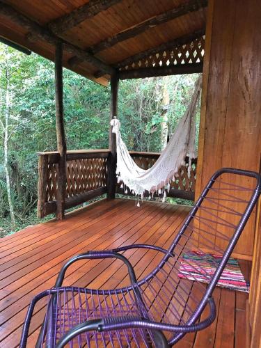 a hammock on the deck of a cabin at Yasí Yateré Reserva Agroecológica in El Soberbio