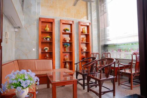 a dining room with a table and chairs and a shelf at DUC MINH HOTEL in Ho Chi Minh City