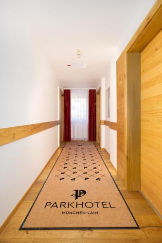 a hallway with a mat on the floor in a house at Park Hotel Laim in Munich