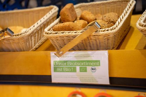 two baskets of bread on a table with a sign at Park Hotel Laim in Munich