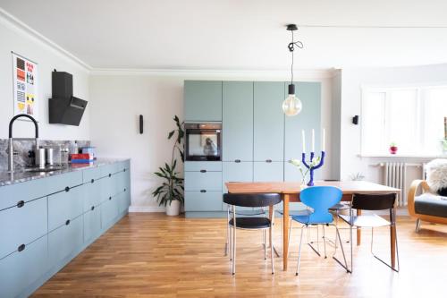a kitchen with a dining room table and chairs at 2bedroom apartment close to centre in Reykjavík