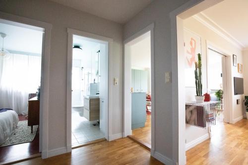 a room with a bed and a hallway with a mirror at 2bedroom apartment close to centre in Reykjavík