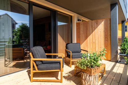two chairs and a table on a patio at Araldo Eco-Lodge in Bosco Chiesanuova