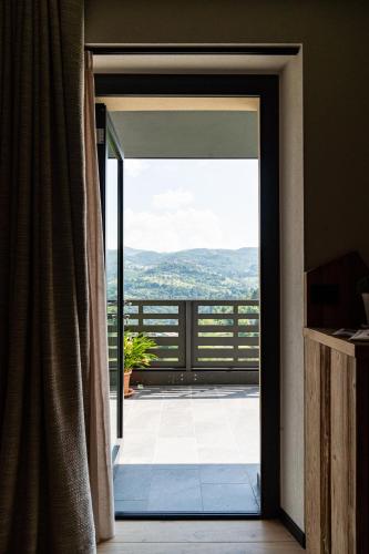 an open door to a balcony with a view at Araldo Eco-Lodge in Bosco Chiesanuova