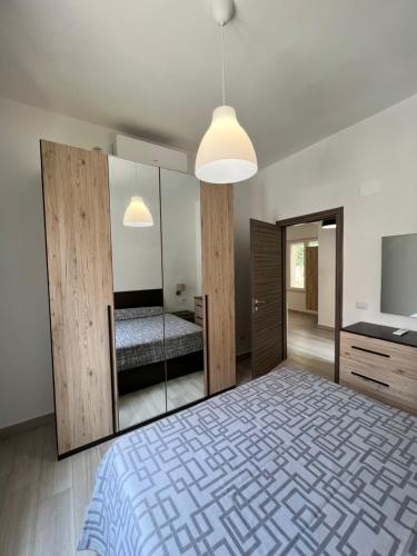 a bedroom with a bed and a mirror at I lecci in Livorno