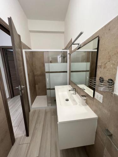 a bathroom with a white sink and a mirror at I lecci in Livorno