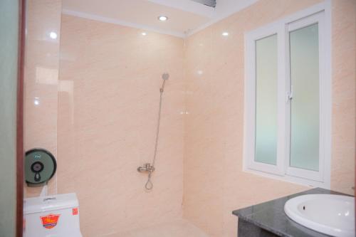 a bathroom with a shower and a toilet and a sink at DUC MINH HOTEL in Ho Chi Minh City