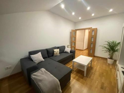 a living room with a couch and a table at Apartamento El Roxu 1 in Arriondas