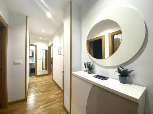 a bathroom with a large mirror on the wall at Apartamento El Roxu 1 in Arriondas