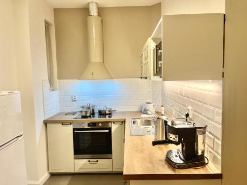 a kitchen with a coffee machine on a counter at Riverbridge Apartments Prague in Prague
