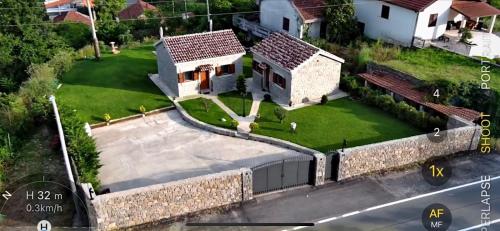 an aerial view of a house with a wall at Apartments Monte Green in Virpazar