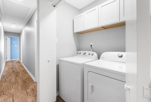 a white laundry room with a washer and dryer at Wave on Wave! Overlooking community pool! in Port Aransas