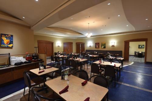 a restaurant with tables and chairs in a room at Victoria Inn Hotel and Convention Center Winnipeg in Winnipeg