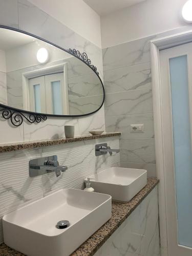 a bathroom with a white sink and a mirror at B&B Le Rocce in Castel San Giorgio