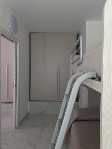 a staircase in a room with white cabinets at B&B Le Rocce in Castel San Giorgio