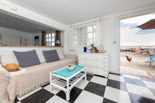 a living room with a couch and a table at Vista Paraiso, Sea breeze facing the sea in La Oliva