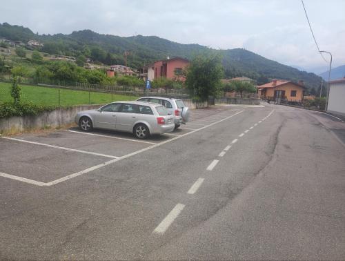 a couple of cars parked in a parking lot at Luminoso appartamento vista lago in Solto Collina
