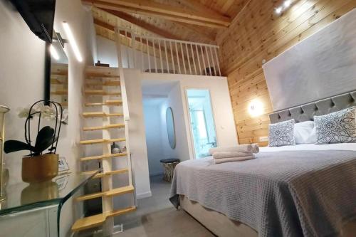 a bedroom with a bed and a wooden wall at Divine Studios Elafonisos B2 in Elafonisos