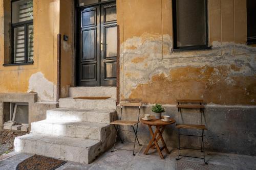 a set of stairs next to a building with a table at Kenti Residence in Ljubljana