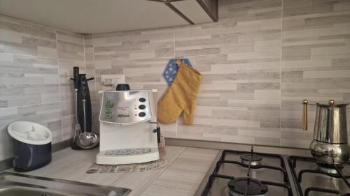 a kitchen counter with a coffee maker on a counter top at Holiday Sun in Badesi