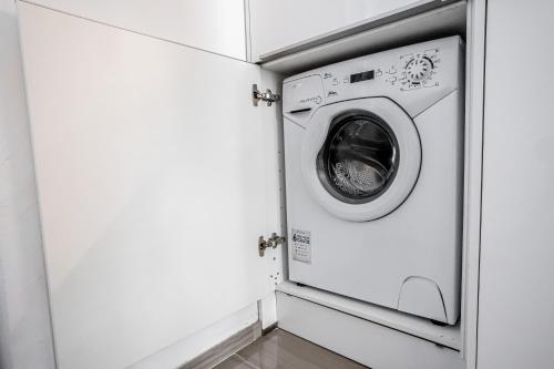 a washer and dryer in a laundry room at Kenti Residence in Ljubljana