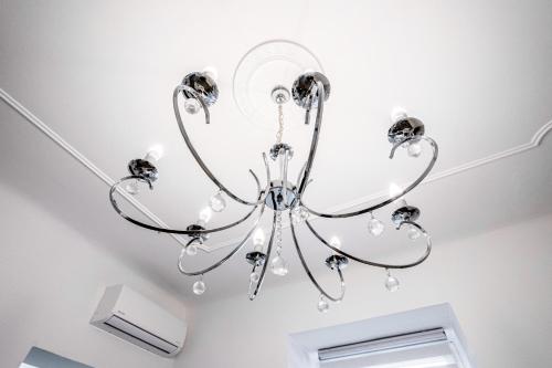 a chandelier hanging from a ceiling in a room at Kenti Residence in Ljubljana