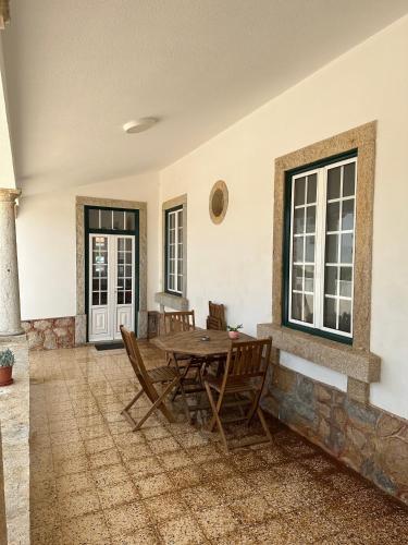 a dining room with a wooden table and chairs at Casa Branca in Ericeira