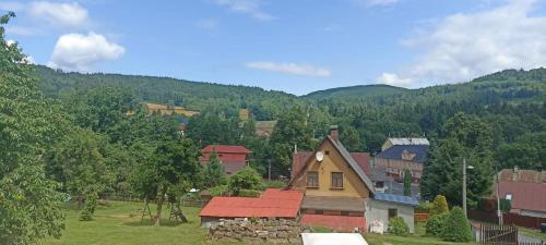 a group of houses with mountains in the background at Chata u Křupalů in Polevsko