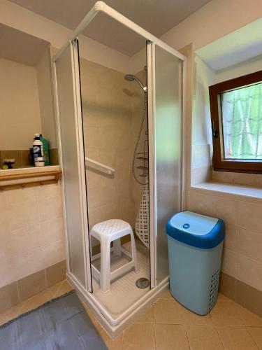 a shower stall with a stool in a bathroom at Relax sul Brembo - Casa Vacanze in Olmo al Brembo